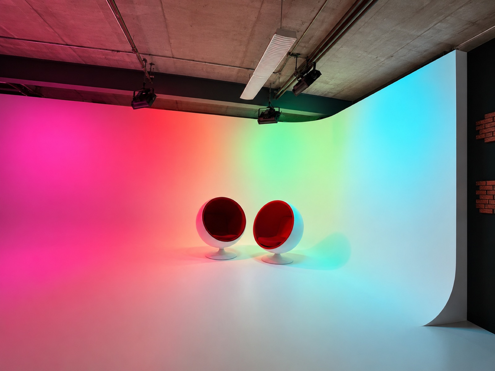 The cyc wall at Silver Sail Studios lit in a full RGB color wash