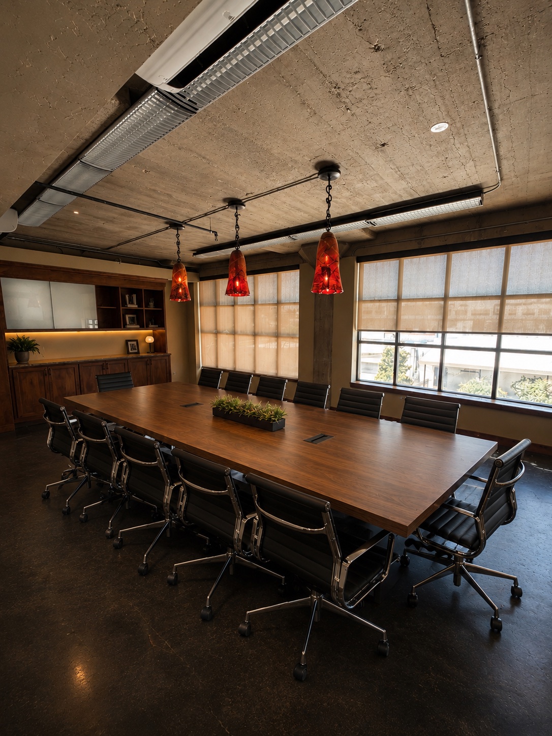 The conference room at Silver Sail Studios with a long table and pendant lighting