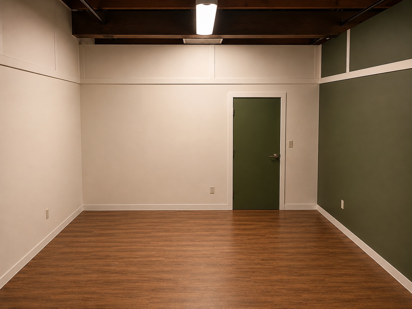 A blank room standing set with neutral walls, a green door, and wood floors at Silver Sail Studios