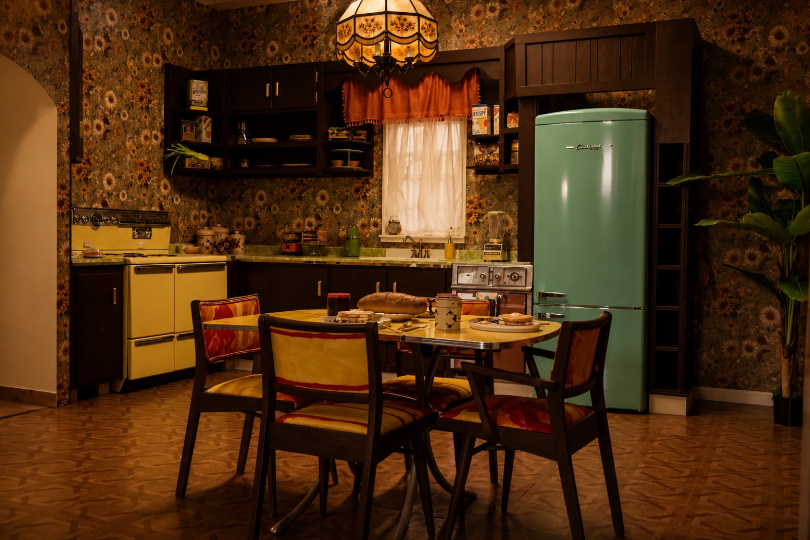 Mid-century kitchen set with mint refrigerator, yellow range, and sunflower wallpaper